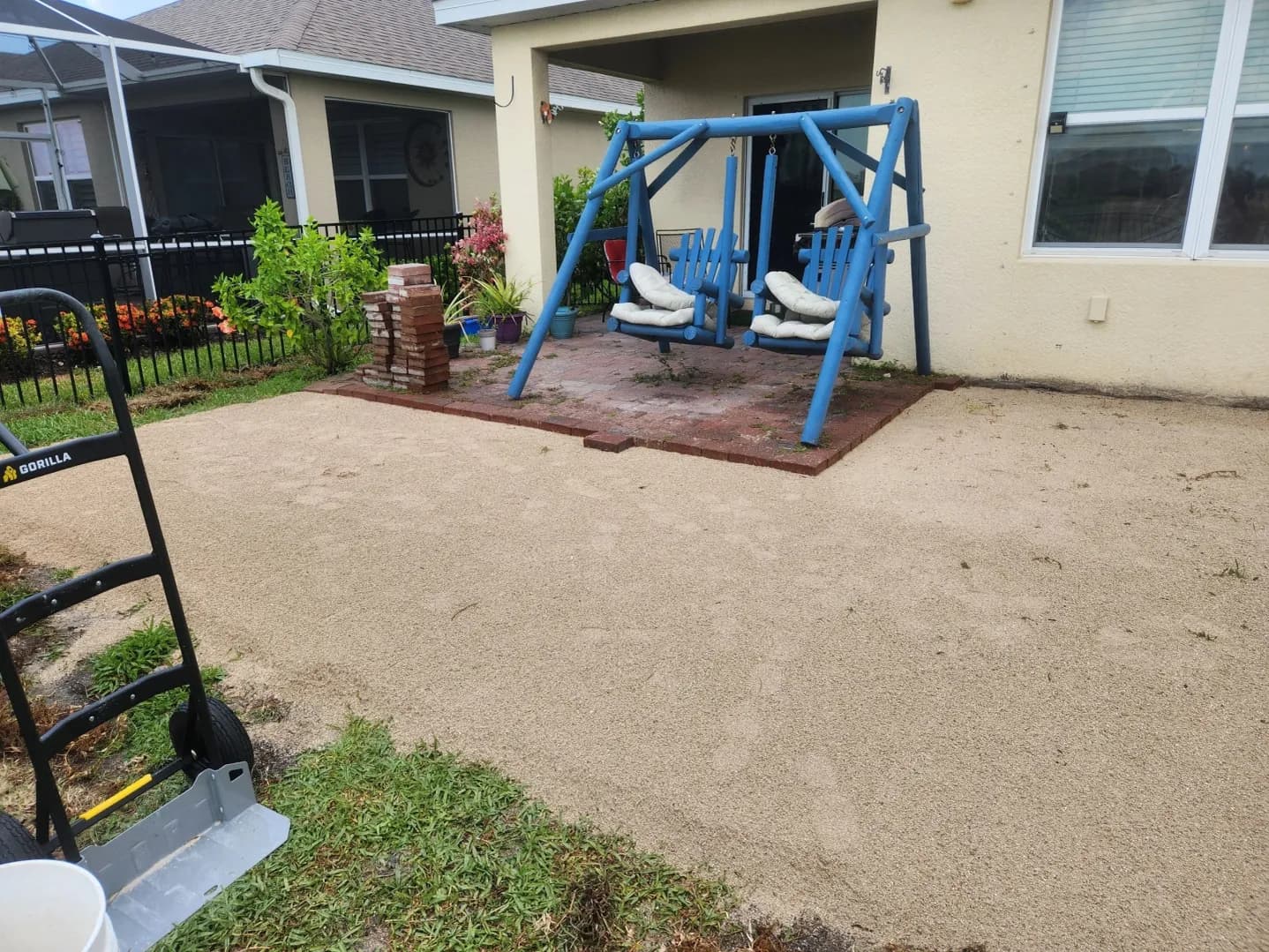 Faded, weathered brick patio before restoration