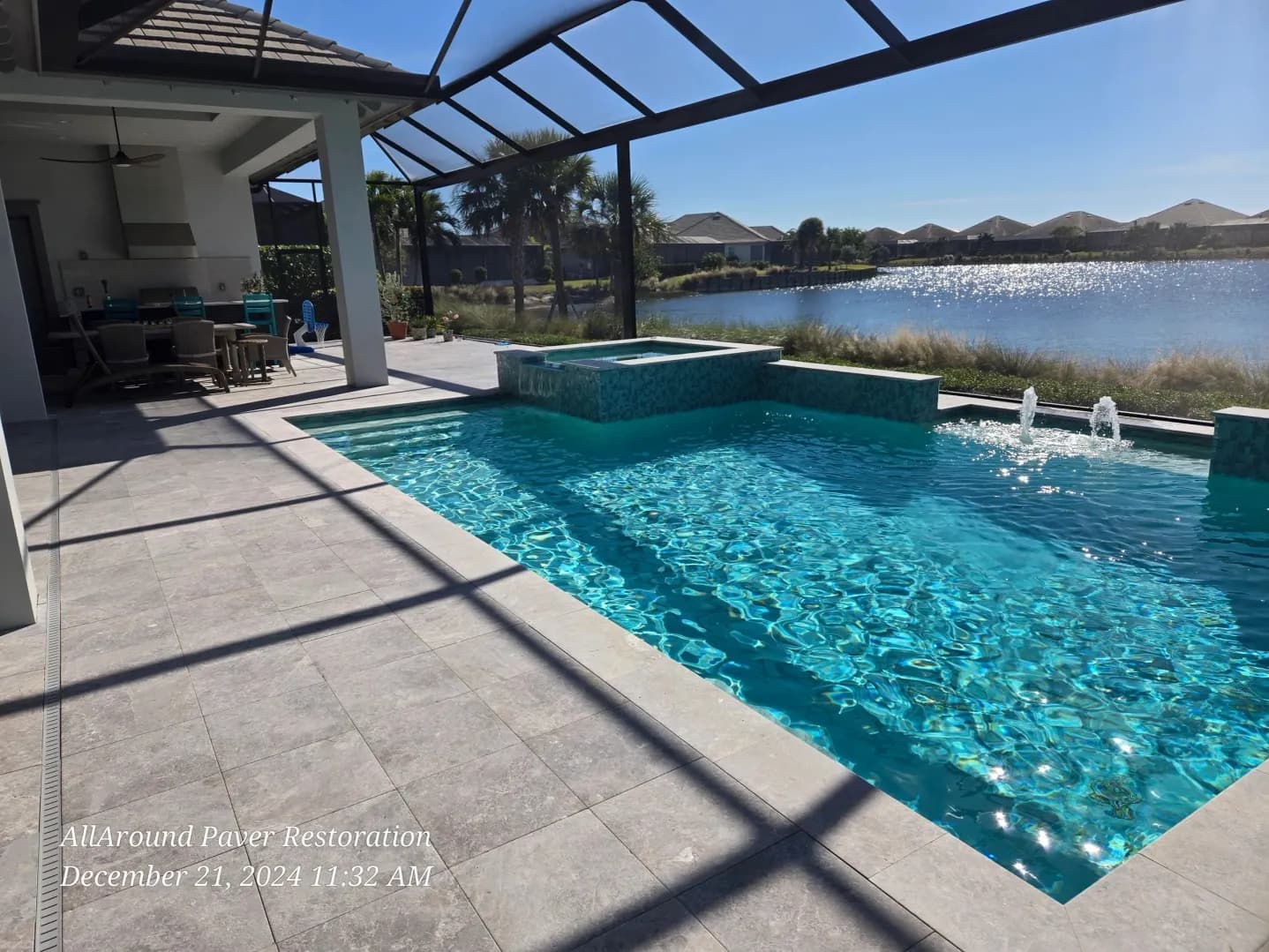 Lakefront travertine paver pool deck, freshly sealed, in Cape Coral